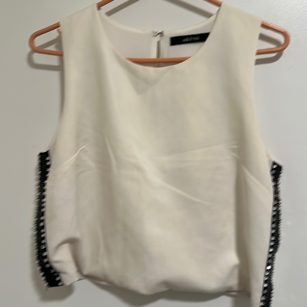 very cute top with black trim and crystals on the sides